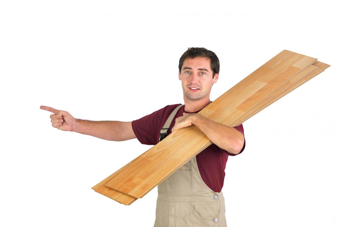 man holds a wood plank